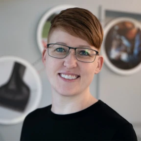 Photo of Ada Deacon from Trimax Mowers sharing her experience working with EvinceDev on customer service mobile app spare part.
